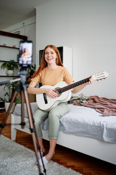 Woman doing live online music lesson from home