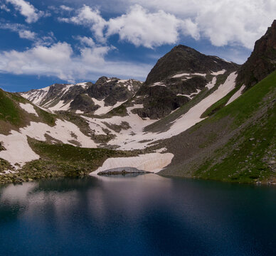 water level photo of a blue lake in alpine valley
