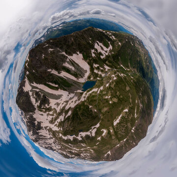 tiny planet panorama of a blue lake in alpine valley
