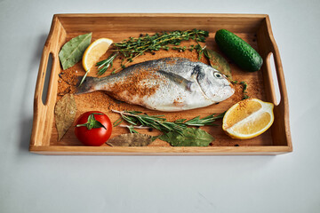 sea fish fresh ingredients lemon on wooden board