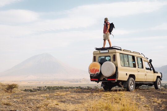 Man on the top of a safari car