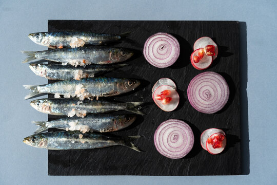Fresh sardines on slate
