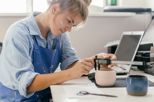 Young woman potter at work