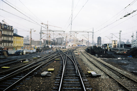 Empty train tracks in a industrial town during grey day
