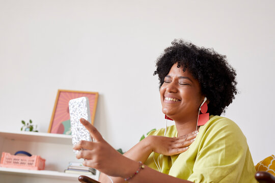 Laughing woman using smartphone