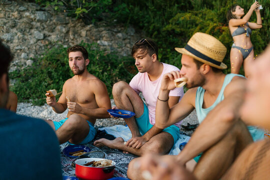 Friends eating on the beach 