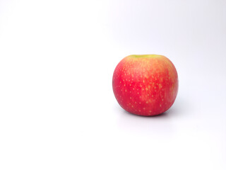 Red apple on a red and white background with copy space.