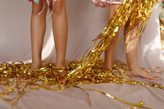  Gold Tinsel Fringe Garland and kids' legs