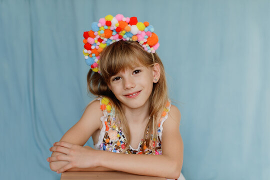 A girl in colorful pompom costume