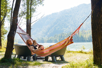Woman napping in hammock in nature