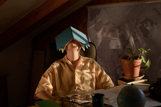 Bored young male with a book on his head