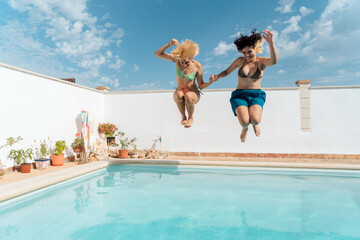Friends diving into the pool