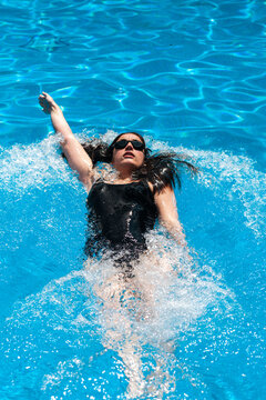 Young woman swimming at pool
