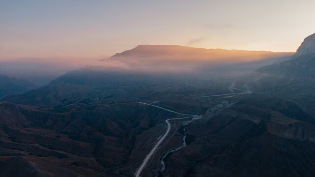 sunbeams hidden behind the mountain - drone view