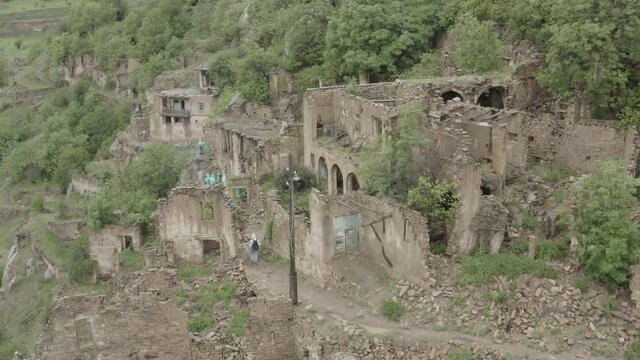 Abandoned in the mountains, the village of Gamsutl . Ghost town, ruins of an old settlement, Impregnable mountain fortress in the Dagestan mountains. Aerial view of an ancient village. Dlog-M 10 bit