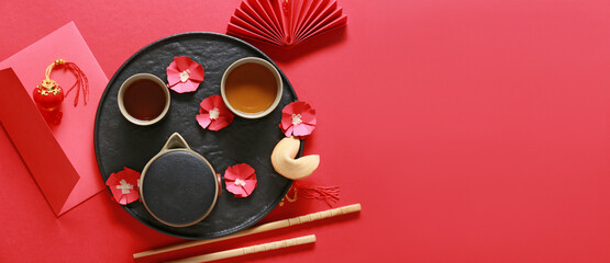 Traditional Chinese tea with envelope on red background with space for text