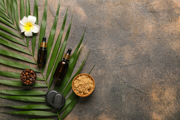 Composition with natural cosmetics and palm leaf on grunge background