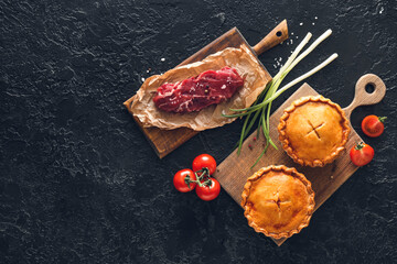 Tasty beef pot pies with meat on dark background © Pixel-Shot