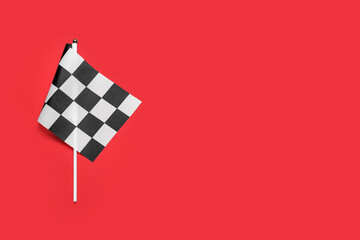 Racing flag on color background, top view