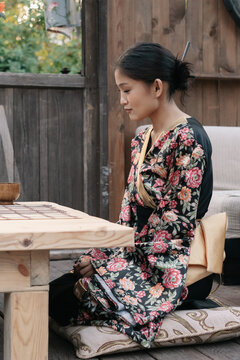 Beautiful woman in kimono, sitting in restaurant