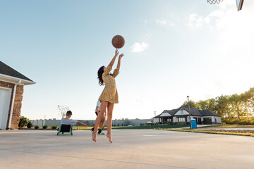 Girl practicing their jump shot. 
