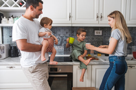 Parents With Two Kids In The Kitchen