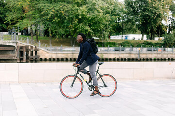 A beautiful black man riding his bike