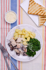Gnocchi with vegetables and meat in a white sauce.