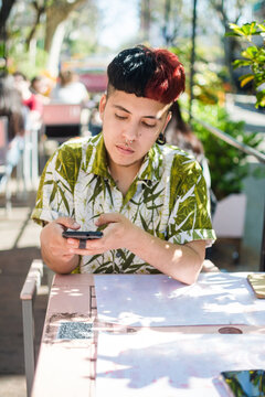 Latino man scanning QR code to obtain digital menu 