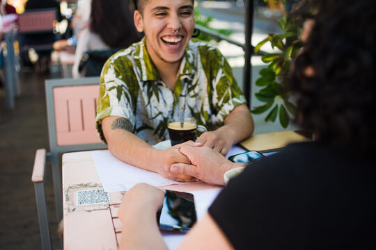 Gen Z latino laughing with his mother