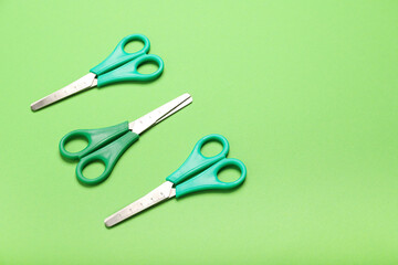 Scissors on color background, top view