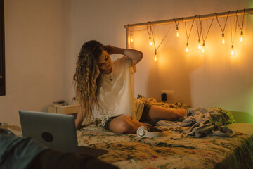 Teen woman in bedroom at night