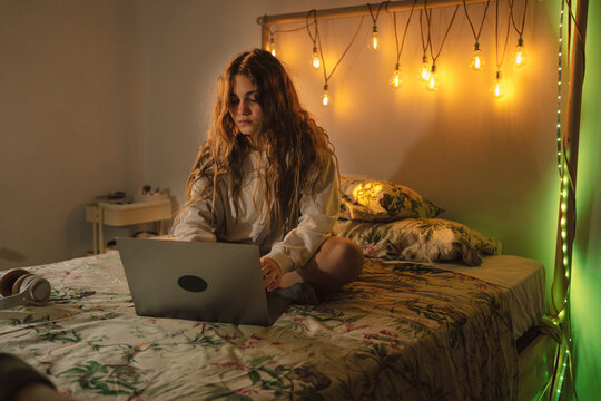 Female with laptop on the bed