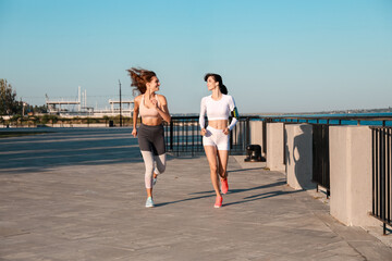 Sporty young sisters running in park