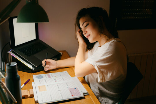 Female student doing homework on her desk