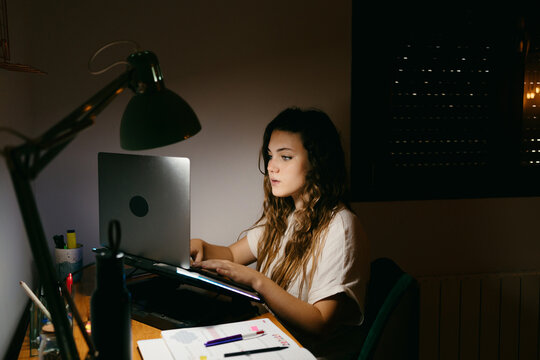 Beautiful tenager girl studying at home