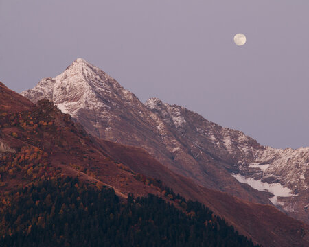 Beautiful snow peak with full moon