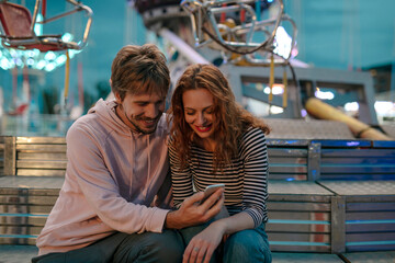 Couple Having Fun At An Amusement Park