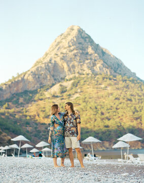 Heterosexual couple walking on the beach 