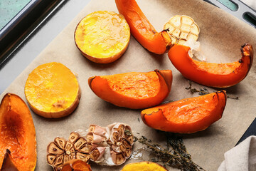 Dish with baked pumpkin pieces on table