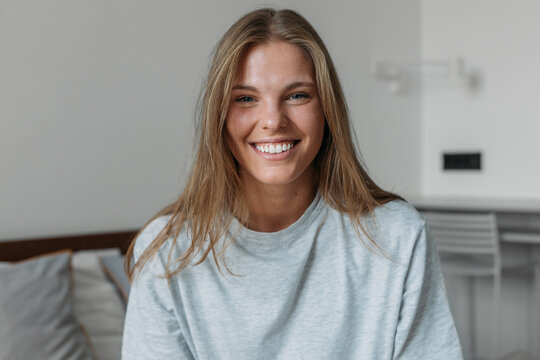 Woman in Bedroom Looking at Camera