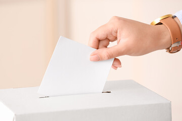 Voting woman near ballot box
