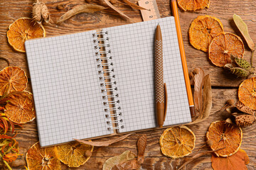 Stationery with dried lemon slices and autumn decor on wooden background