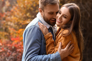 Fototapeta premium Beautiful young couple hugging in autumn park