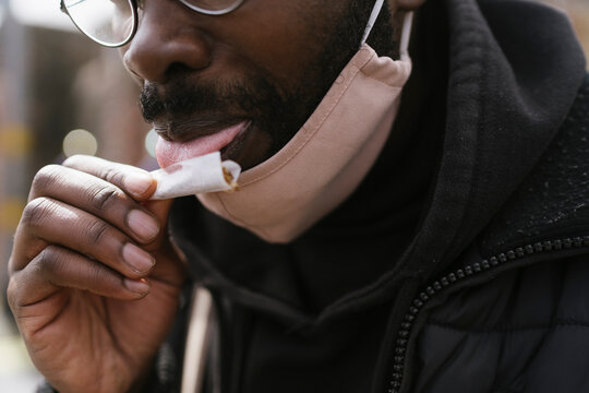 Anonymous Man is Rolling a Cigarette 