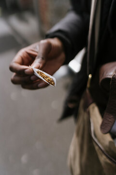 Anonymous Man is Rolling a Cigarette 