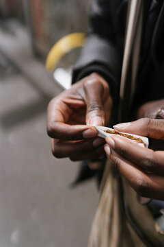 Anonymous Man is Rolling a Cigarette 