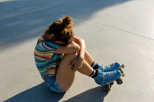 Suffering roller skater girl in sunligh