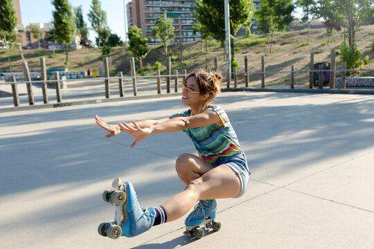 Roller-skate in skate park keeping balance on one foot