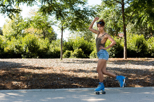 Stylish Roller-skate dancer making a pirouette outdoors